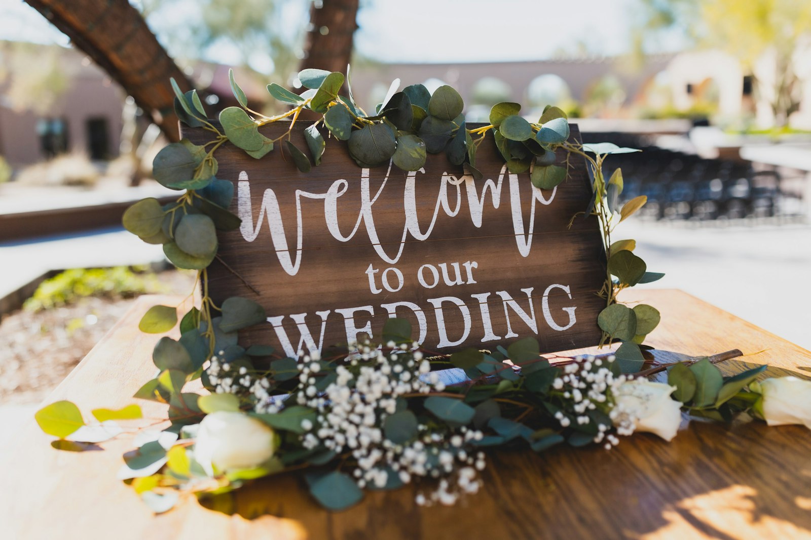 Wooden wedding welcome sign wrapped in eucalyptus and baby's breath